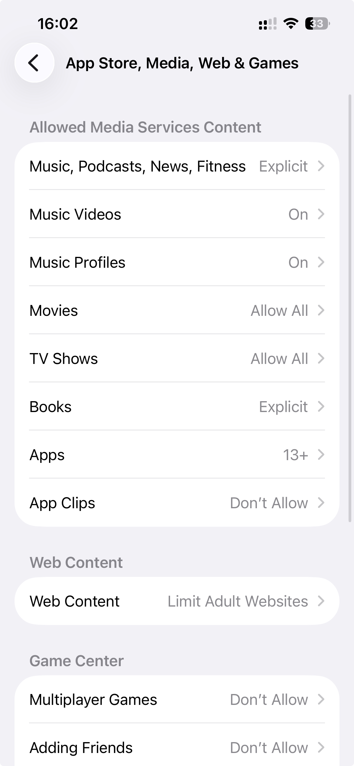 iPhone Content & Privacy Restrictions screen showing Apps set to 13+ and Web Content set to Limit Adult Websites